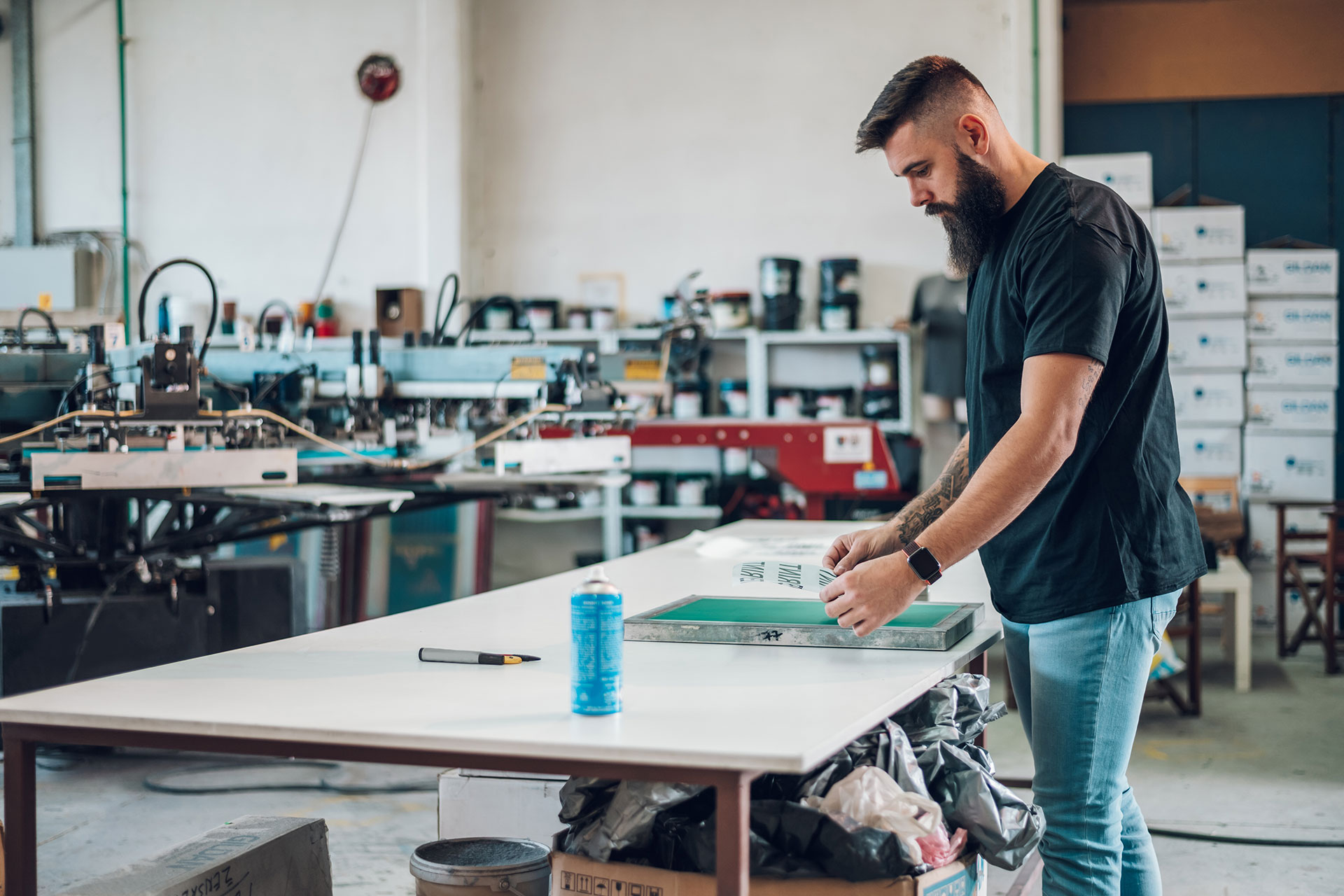 Male worker preparing screen printing film in work qwcptexa