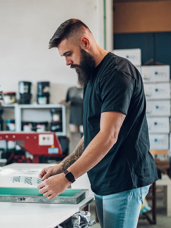 Male worker preparing screen printing film in work qwcptex.jpg